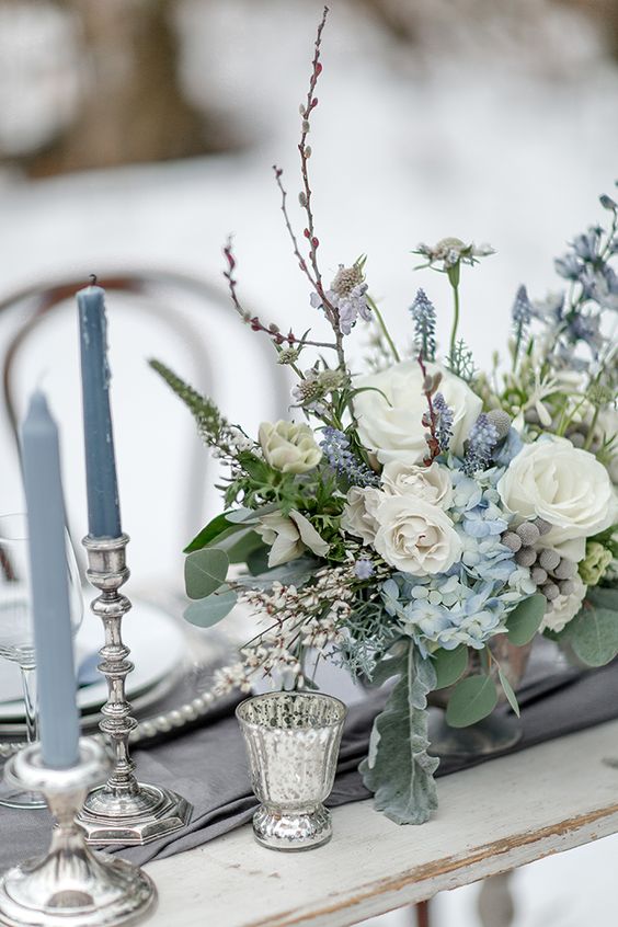 White roses and greenery in centerpiece