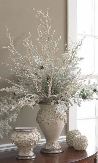 White dried flower spray in silver vase