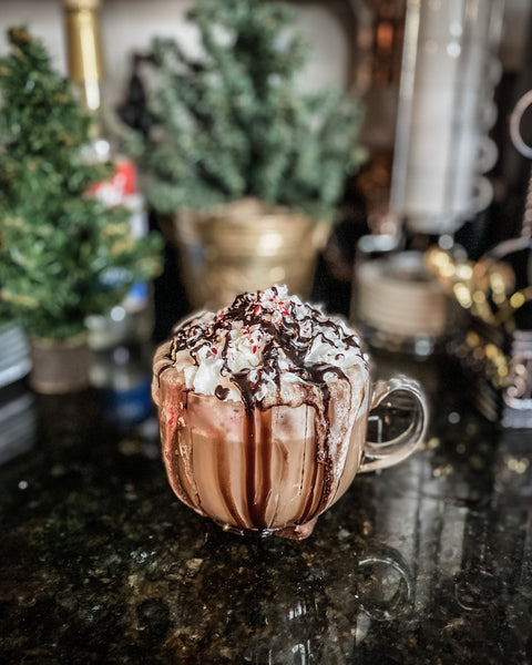 Peppermint Mocha latte with chocolate and whipped cream spilling over sides