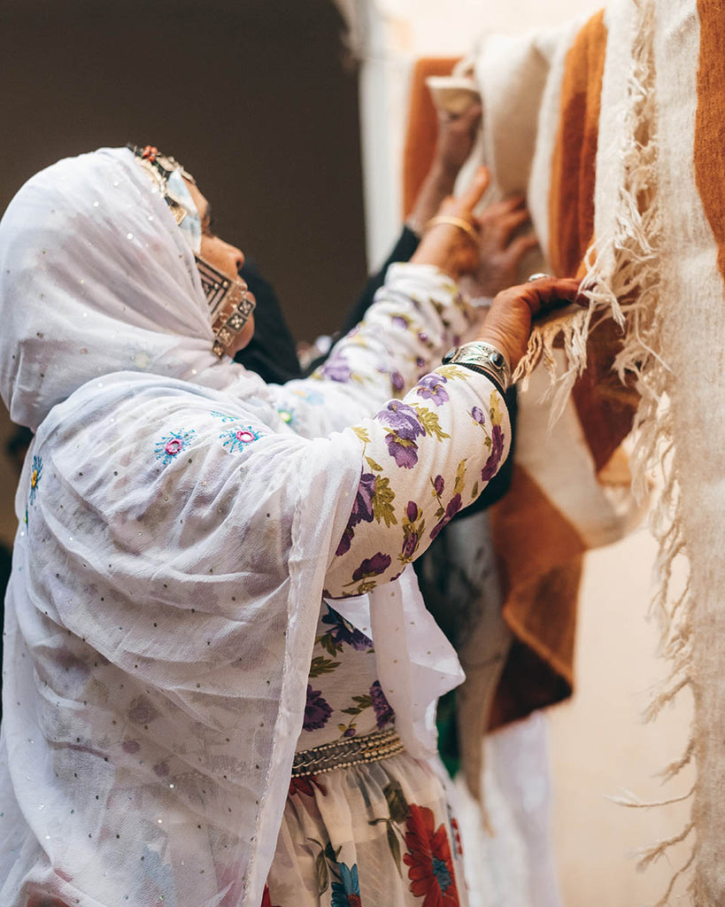 Berber Craftswoman weaving a carpet