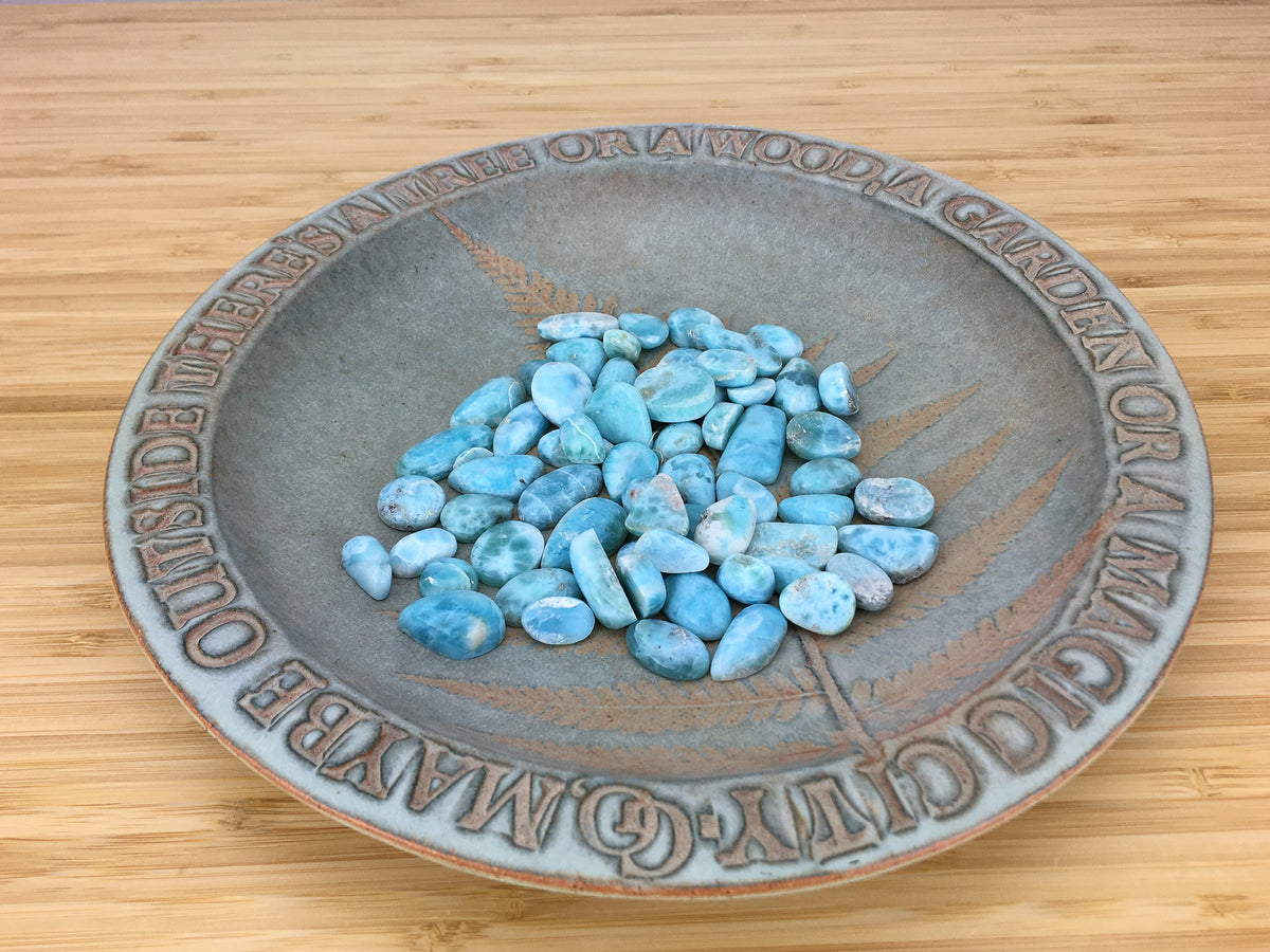 numerous lacrimal cabochons on a ceramic plate.