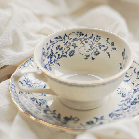 HAND-PAINTED BLUE AND WHITE CERAMIC COFFEE CUP AND SAUCER