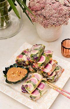 Vibrant summer rolls served on a blush pink serving platter