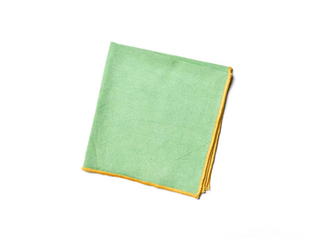 Overhead View of Folded Square Sage and Brass Color Block Napkin Showcasing Closer Look at Design Details