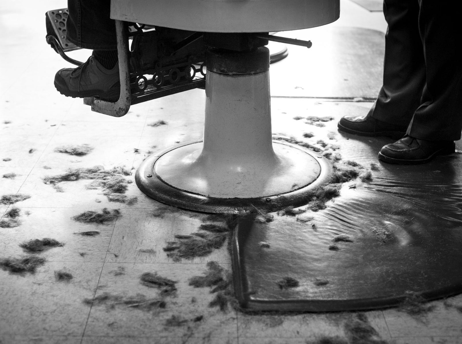 Barbershop chair with hair around it