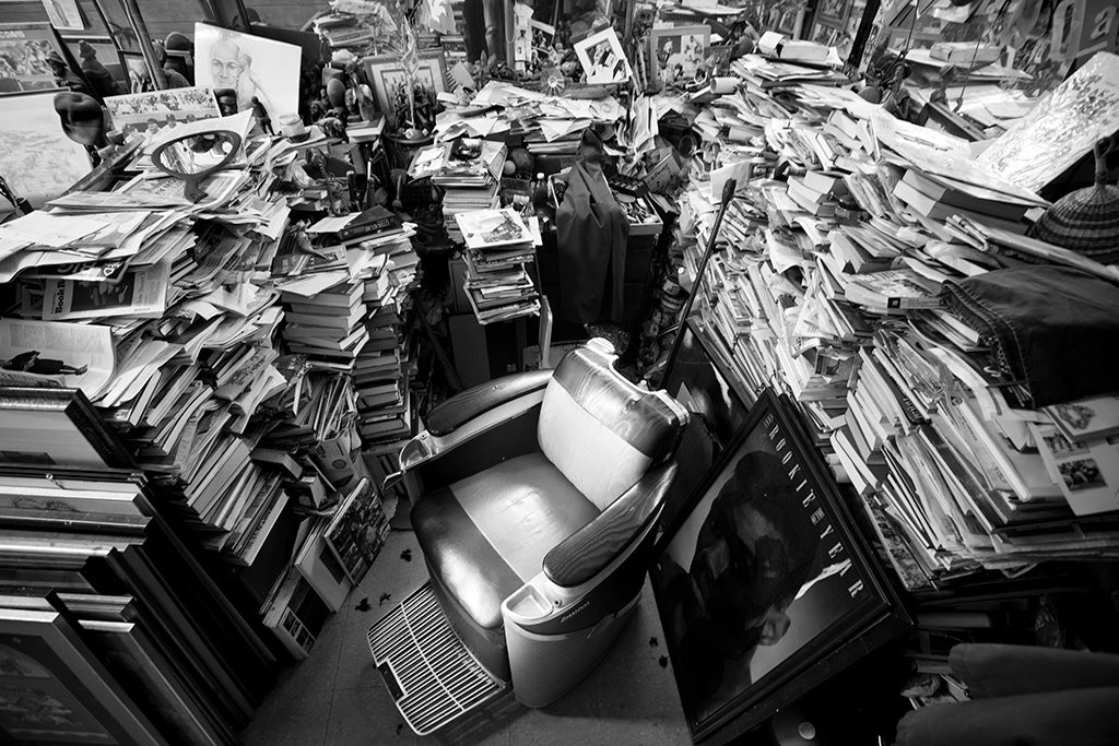 Piles of books around a barber chair