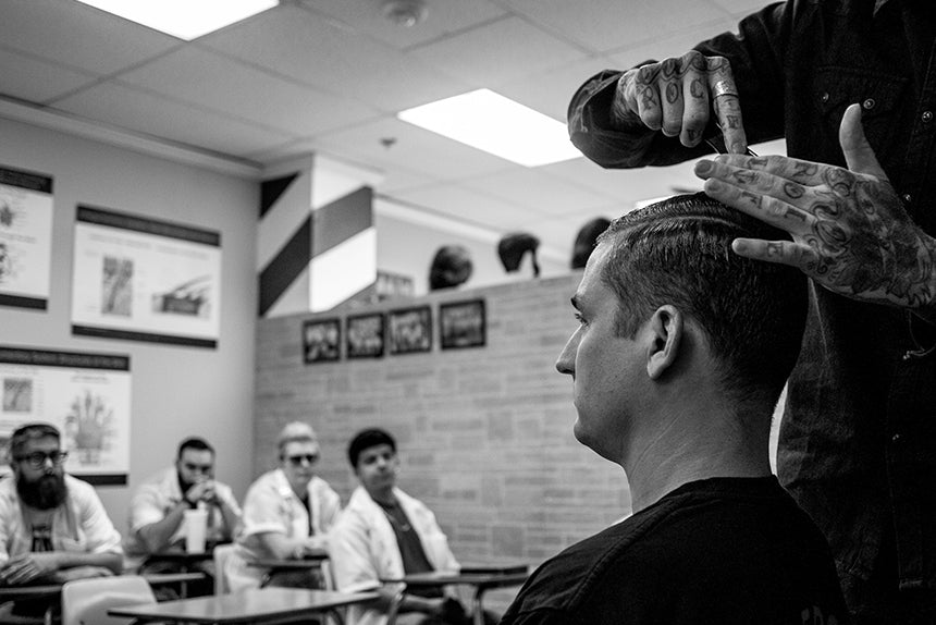 Barber styling mans hair