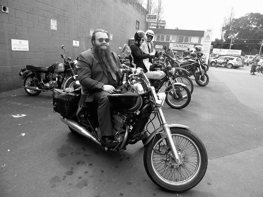 Man with long beard on motorbike