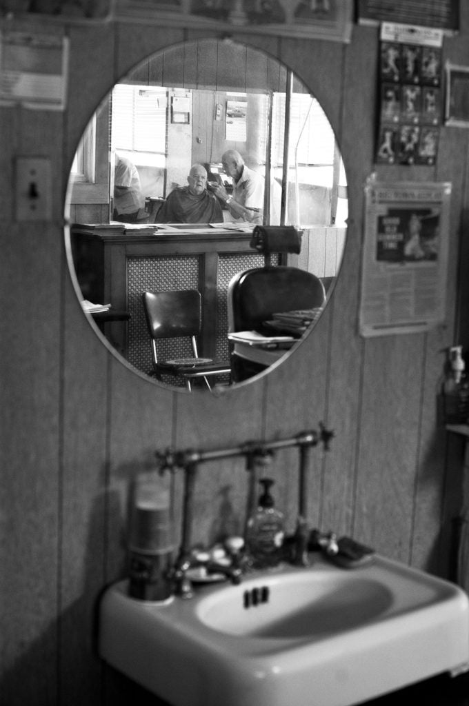 Man getting haircut in the mirror