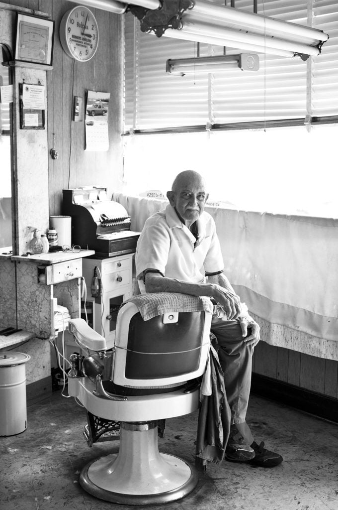 Barber sitting on barber chair