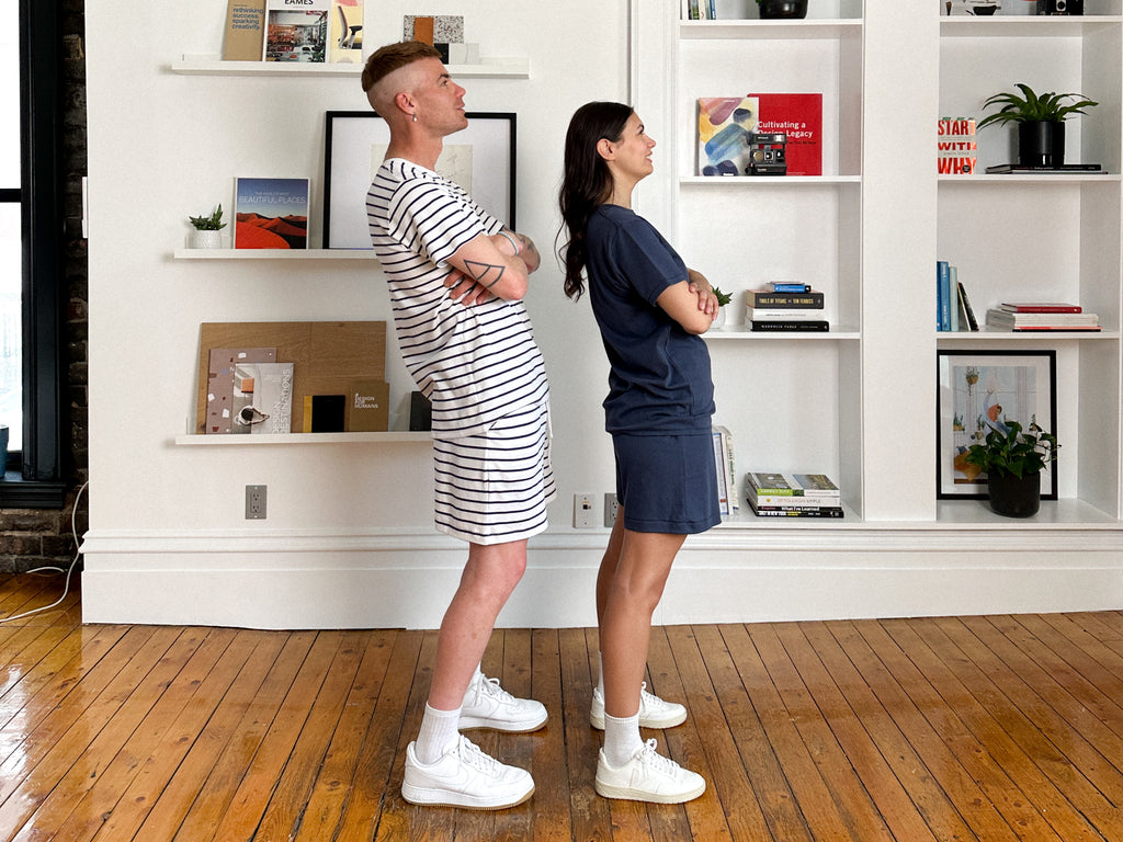 Cory and Marietta wearing matching Pima cotton sets standing facing the right with their arms crossed 