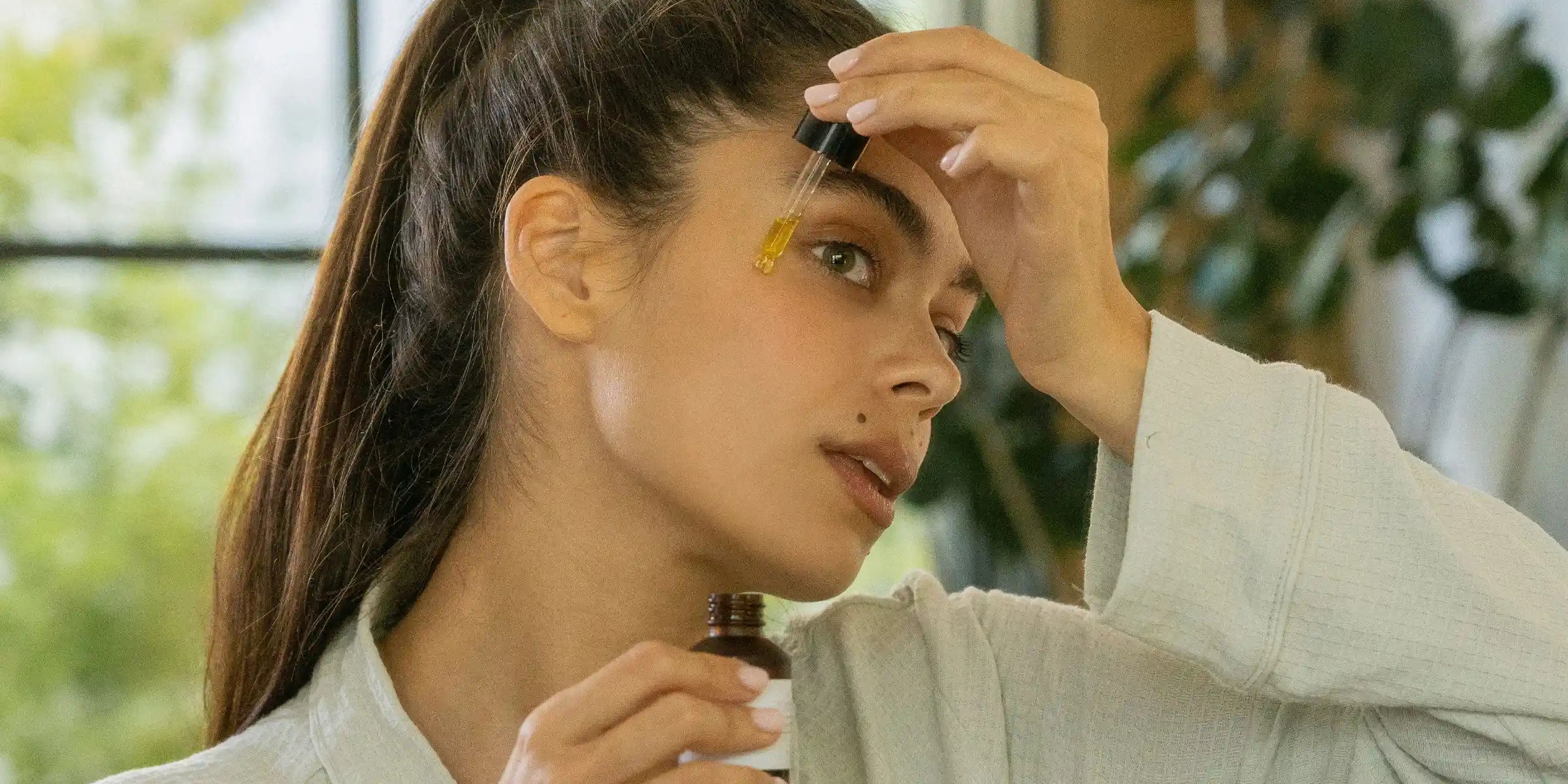 woman applying skincare on face