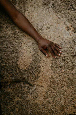 Akasha blends extended arm on sandy ground