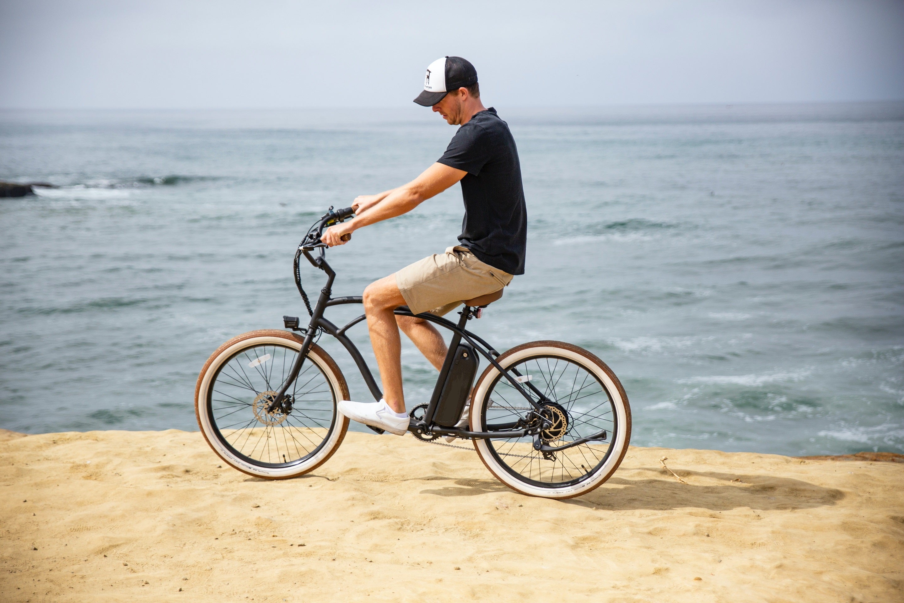 Man riding ebike around the beach