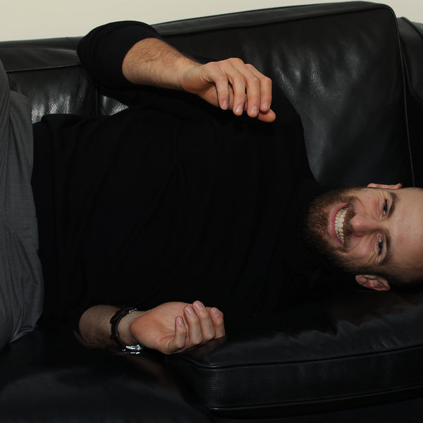 françois-alu-extended-on-a-black-sofa-and-smiling-big-size-picture-at-timothee-parisfrançois-alu-extended-on-a-black-sofa-and-smiling-big-size-picture-at-timothee-paris