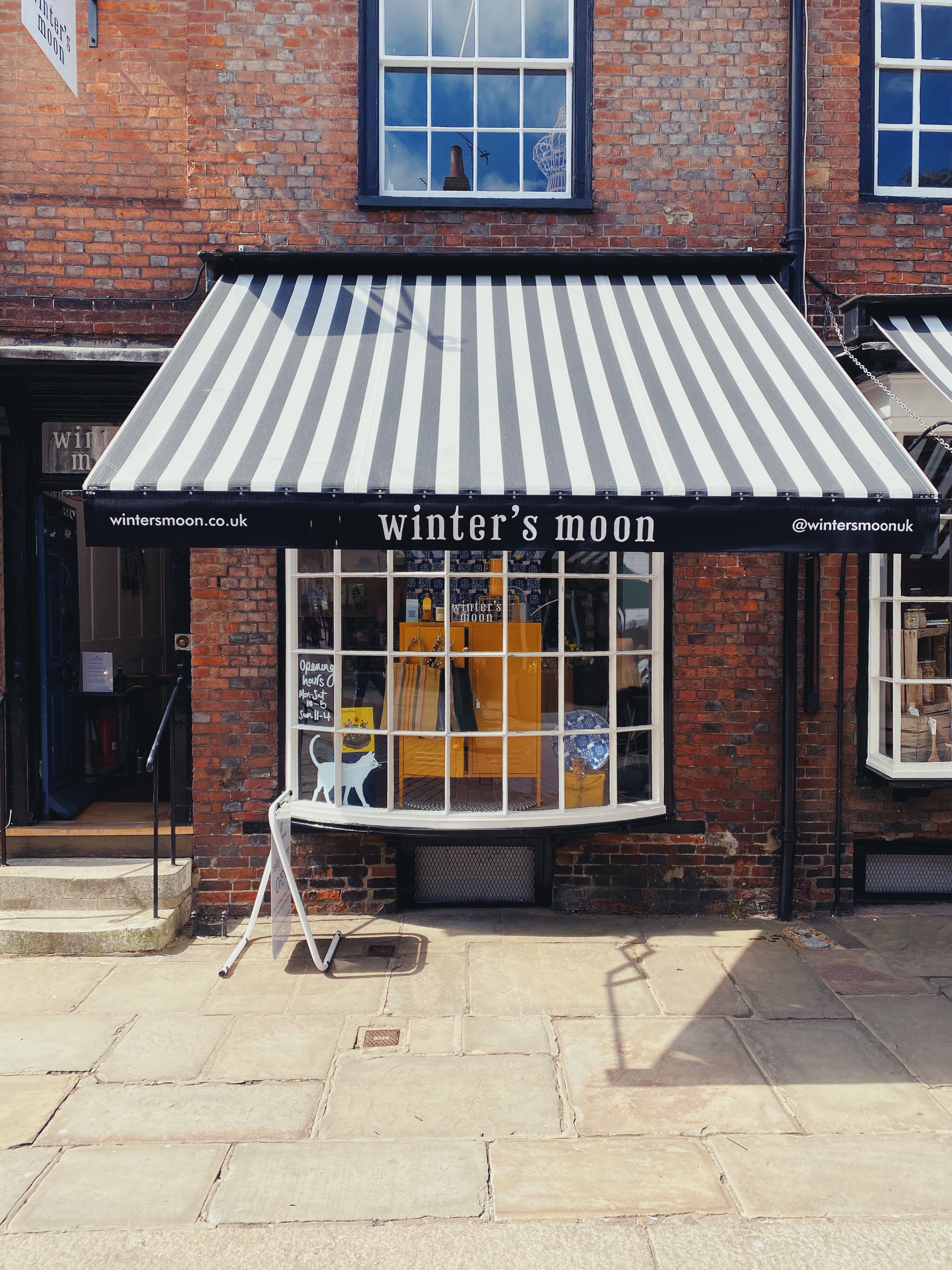 Winter's Moon Shop Front with black and white awning