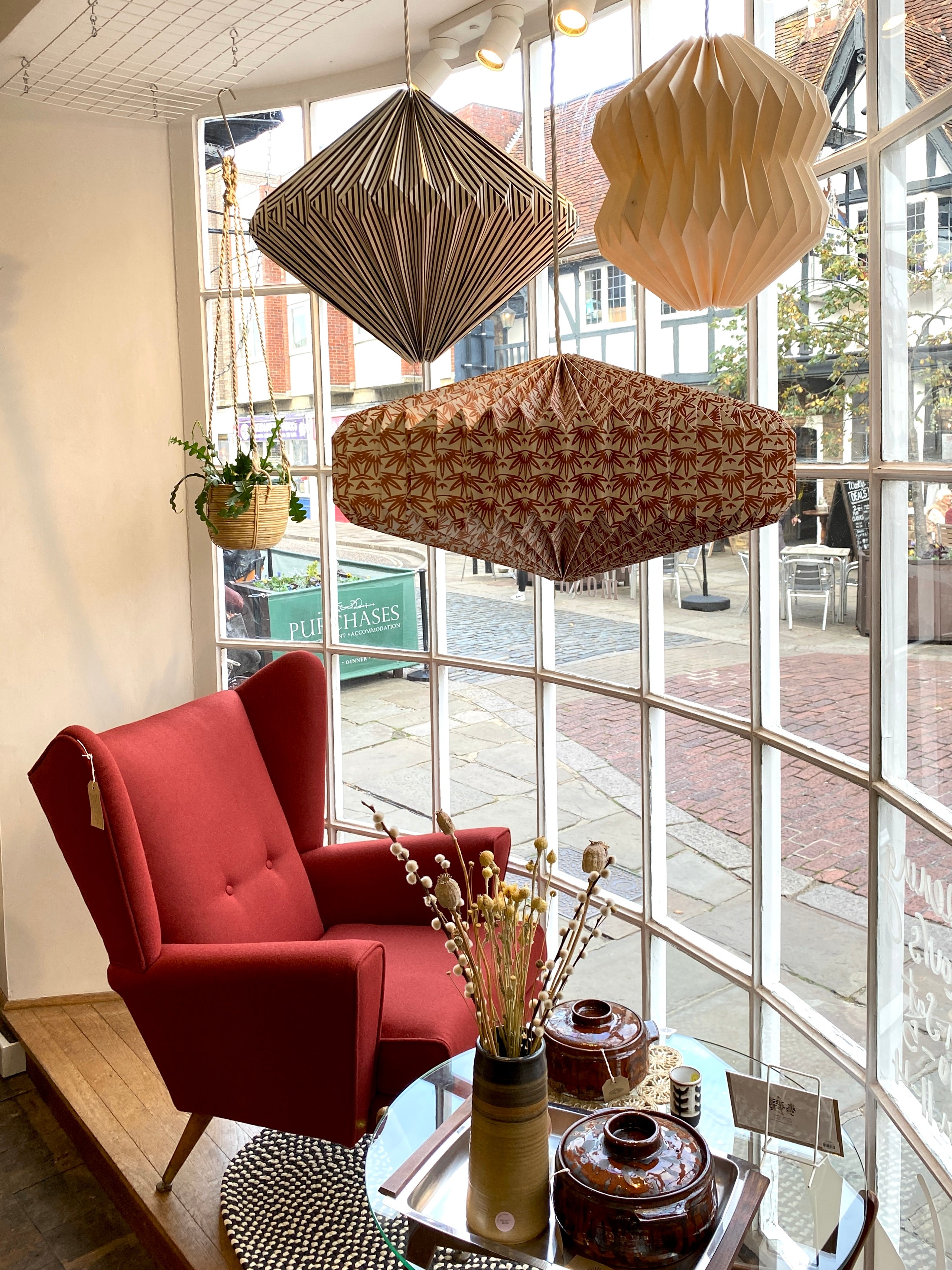 autumn window featuring rust red mid-century wing back arm chair