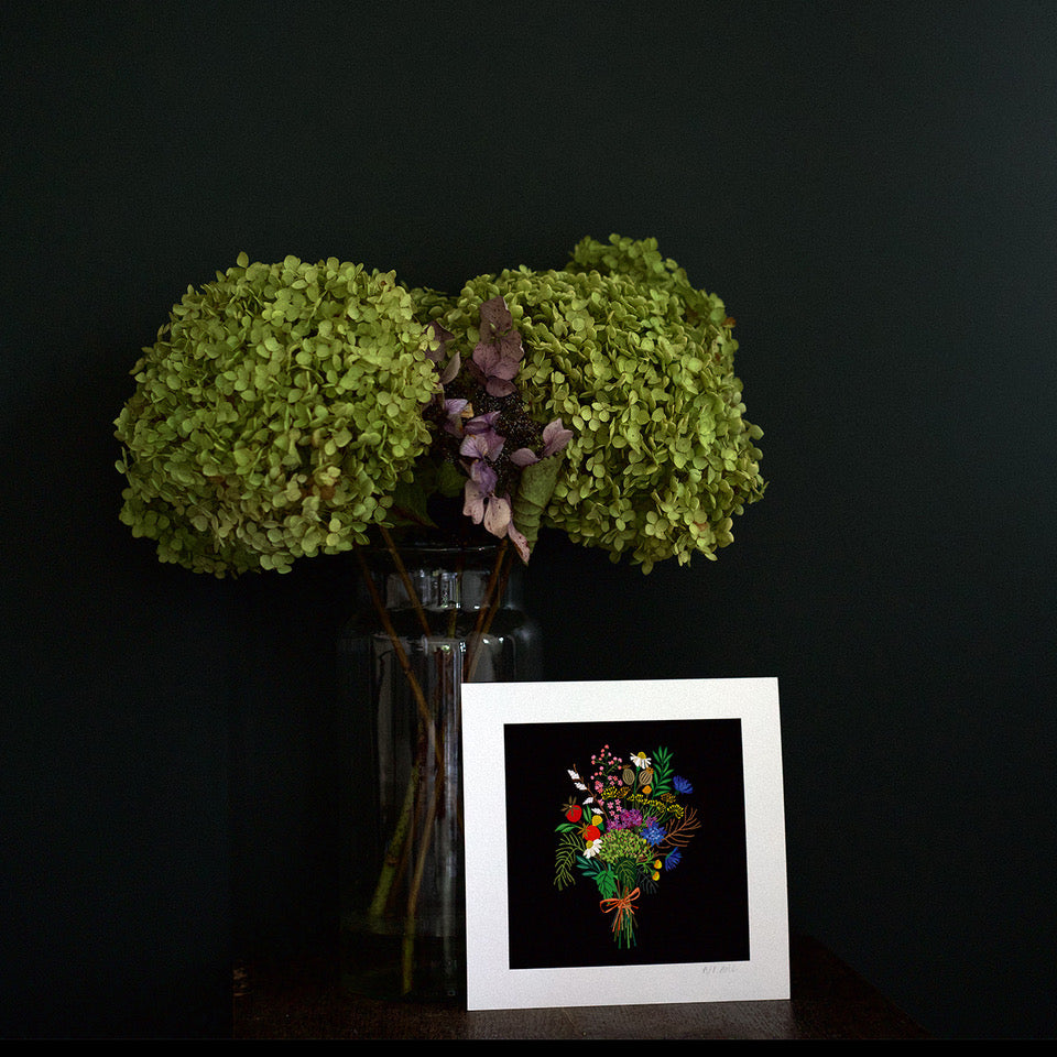 Dark moody room with a Art print resting against a vase of flowers