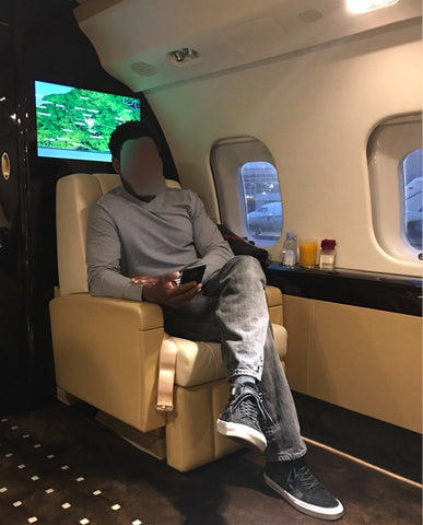 Man sits first class on flight.