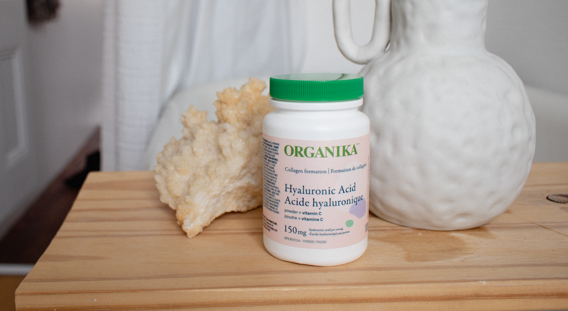 A bottle of Organika's Hyaluronic Acid capsules on a table