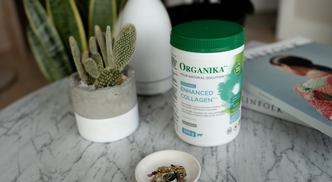 Organika's Enhanced Collagen Original on a table with a plant and some books