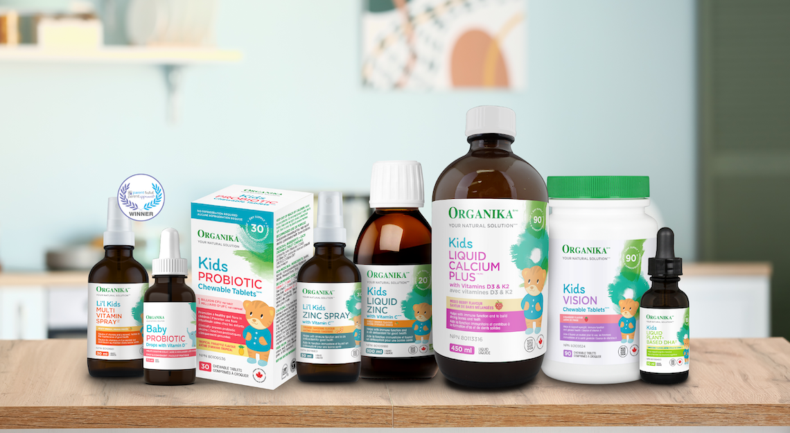 A collection of kids supplements by Organika on a kitchen table
