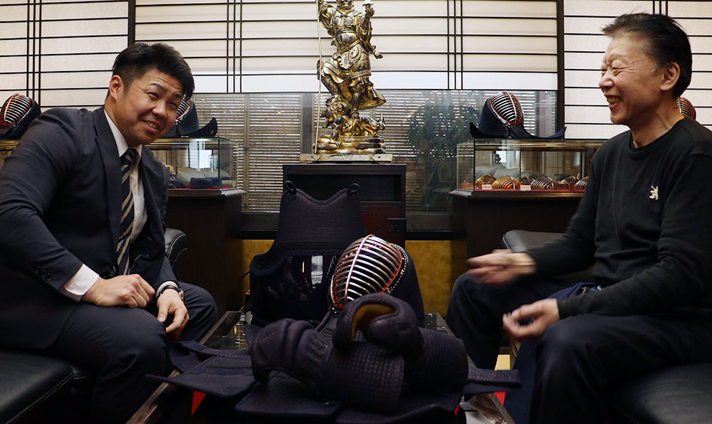 Tozando's Kendo Bogu craftsman, Onishi Akira talking with multiple-time All Japan Kendo champion, Nishimura Hidehisa