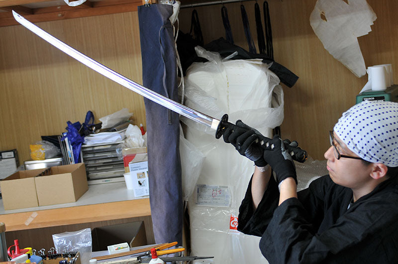 Tozando Iaito sword craftsman is inspecting the finished product.