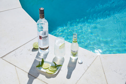 Fever-Tree soda water bottle served with vodka on a pool side with ice