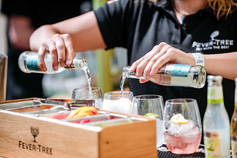 Bartender puring 2 bottles of Fever-tree at the same time