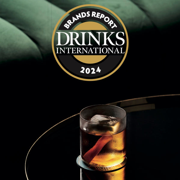 Drinks International Report 2024 square cover with logo on top and glass of iced whiskey on a table and a green sofa on the background