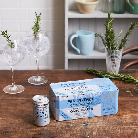 Fever-Tree refreshingly light tonic water in can and a box of 8 cans on a kitchen counter