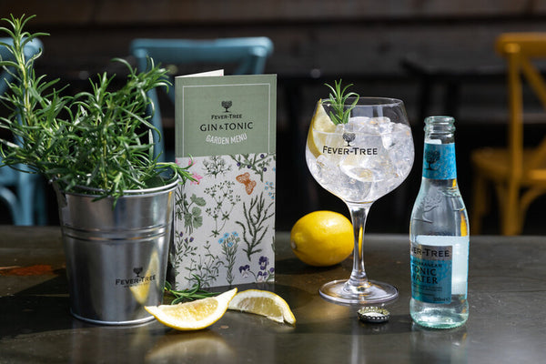 Fever-Tree Mediterranean tonic water on a round ice glass garnished with rosemary and lemon peel