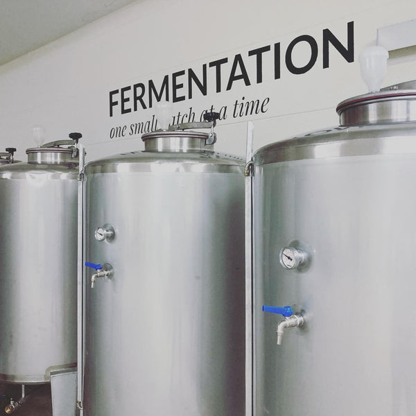 Kosapan distillery fermentation room with metal silos tanks