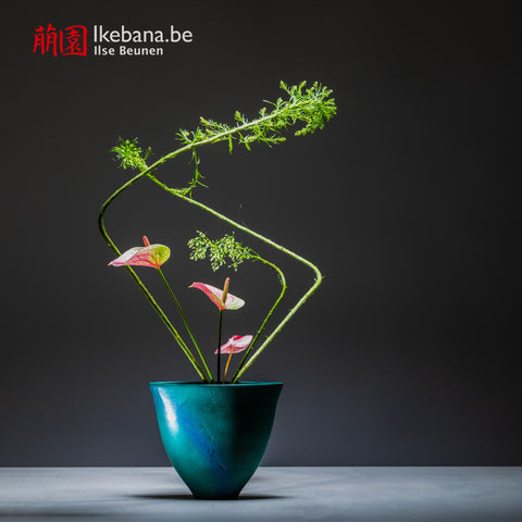 Ikebana florwer composition with blue vase