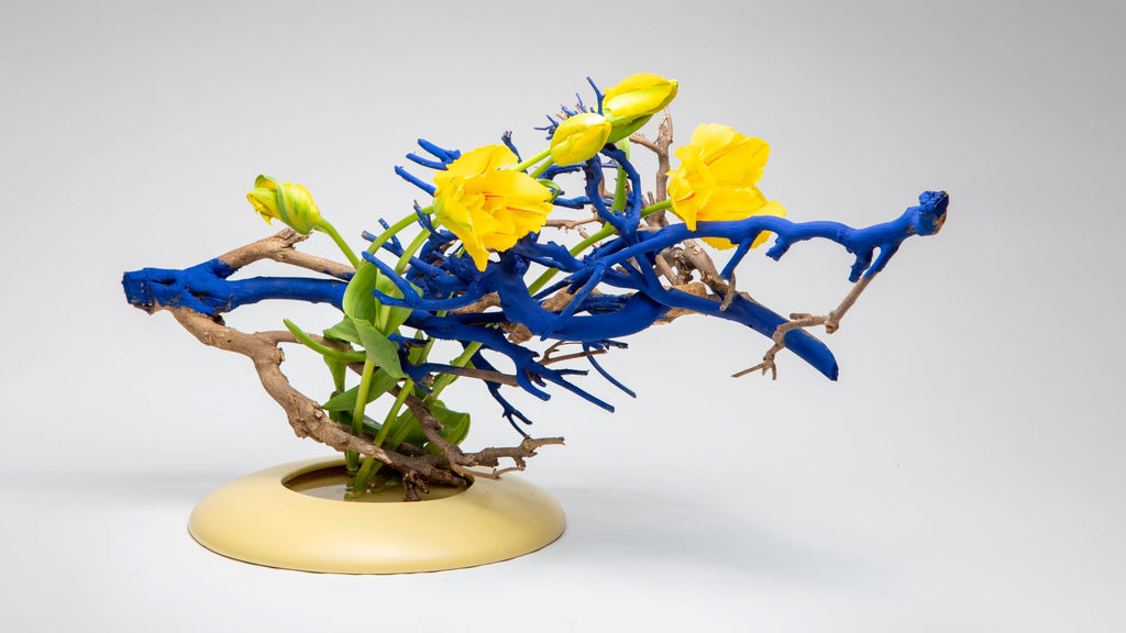 Ikebana set combination of branches painted in blue and yellow flowers