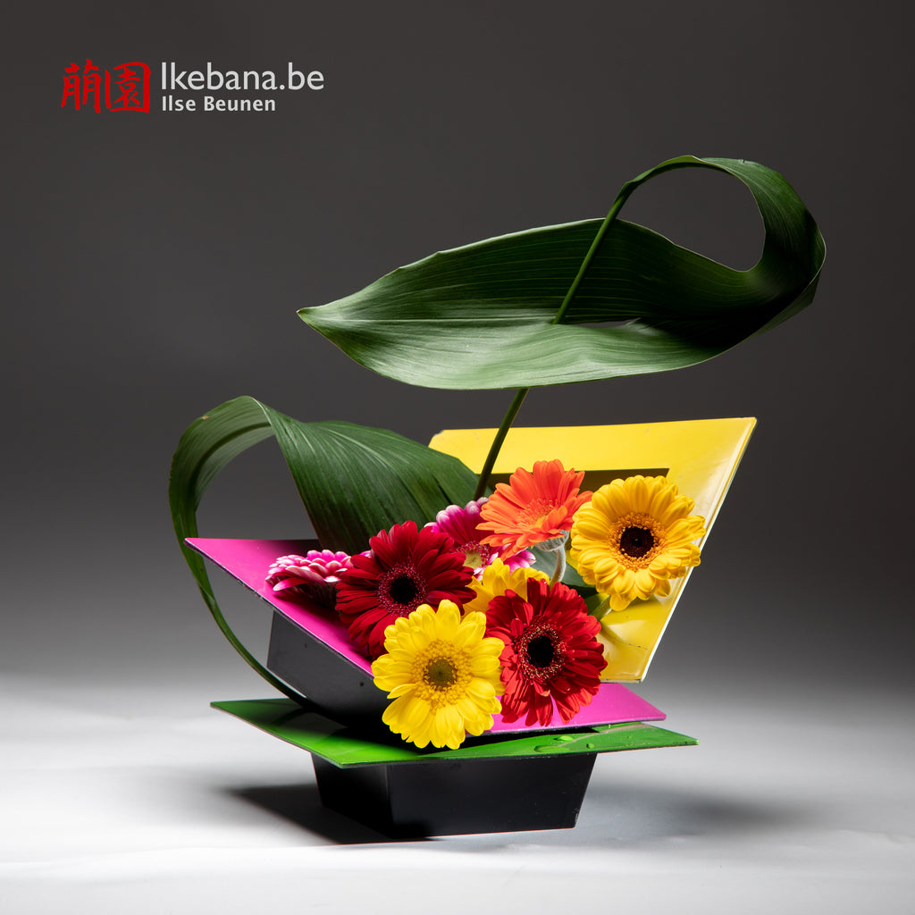 Ikebana composition with red and yellow flowers