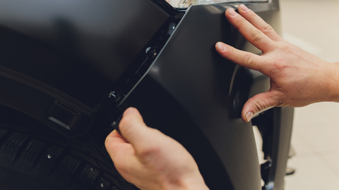 A man installing Front Bumper Grill