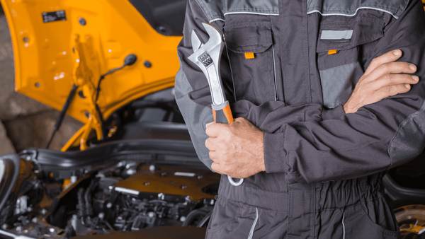 A man maintaining a car