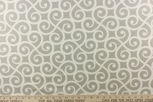This fabric feature a delightful design of swirled lines that touch sides in white on a light gray background.