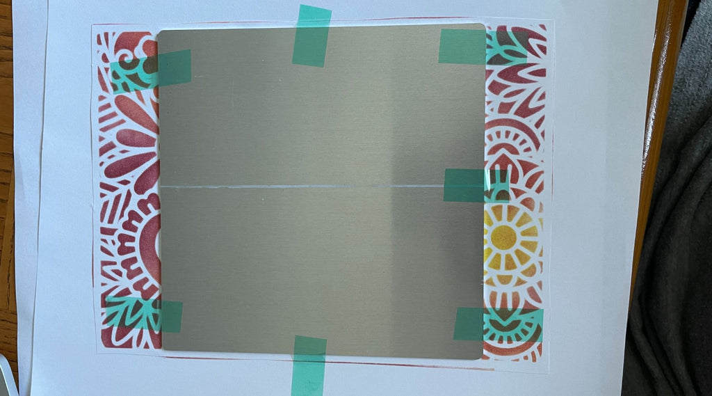 secured decorative metal panel on paper before transfer