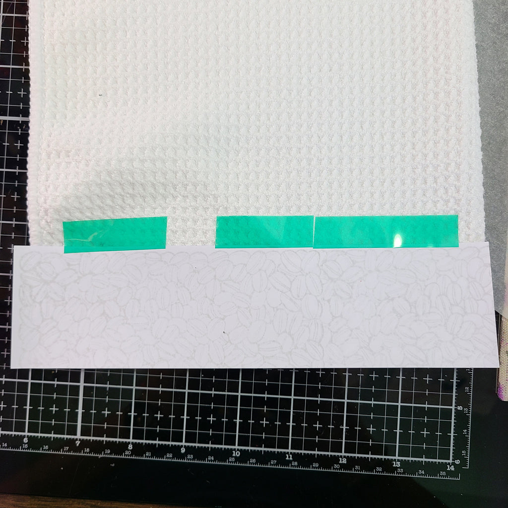 border secured to kitchen towel with heat tape