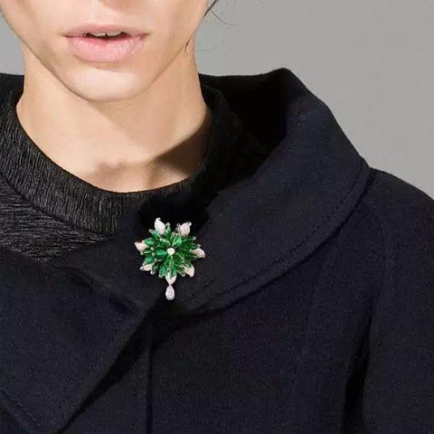 jade brooch on black coat collar