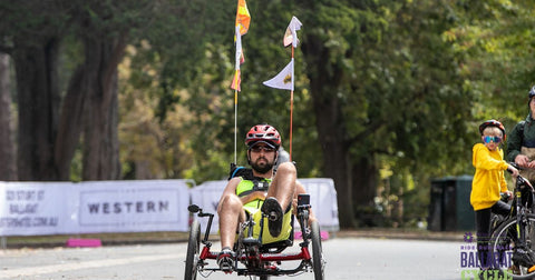 Tommy Q riding a recumbent bike in support of Stroke Foundation Australia