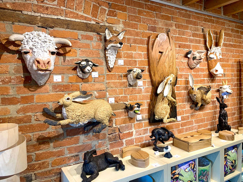 Large handmade ceramic animal heads, mounted to the Gallery's brick wall.