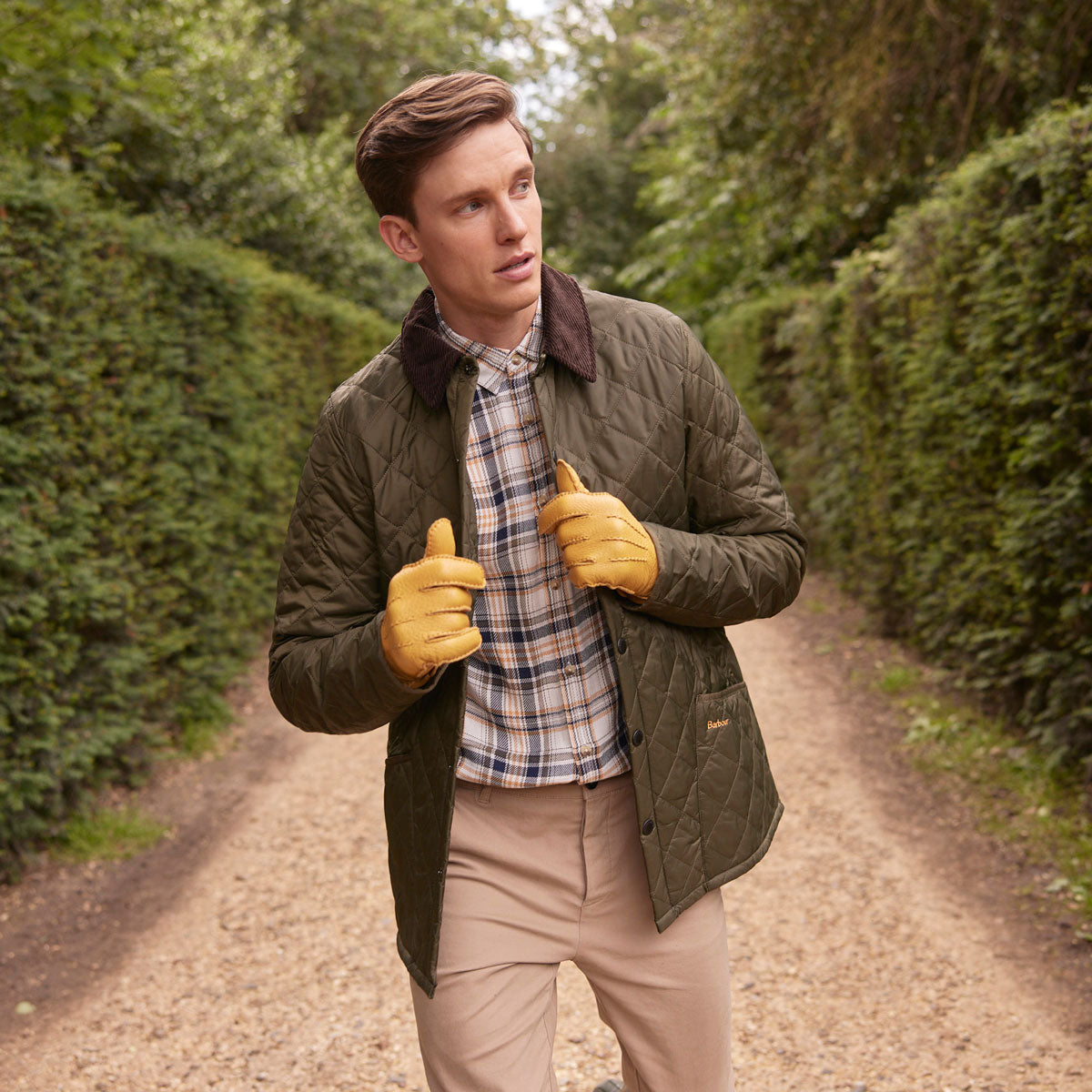 Man wearing peccary leather gloves in cork whilst walking in the park