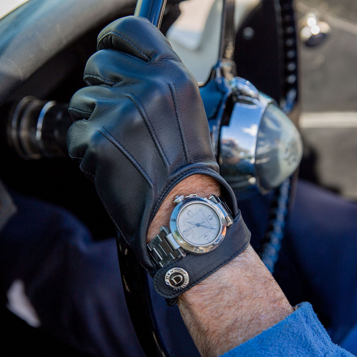 Man wearing leather driving gloves with large keyhole design in black