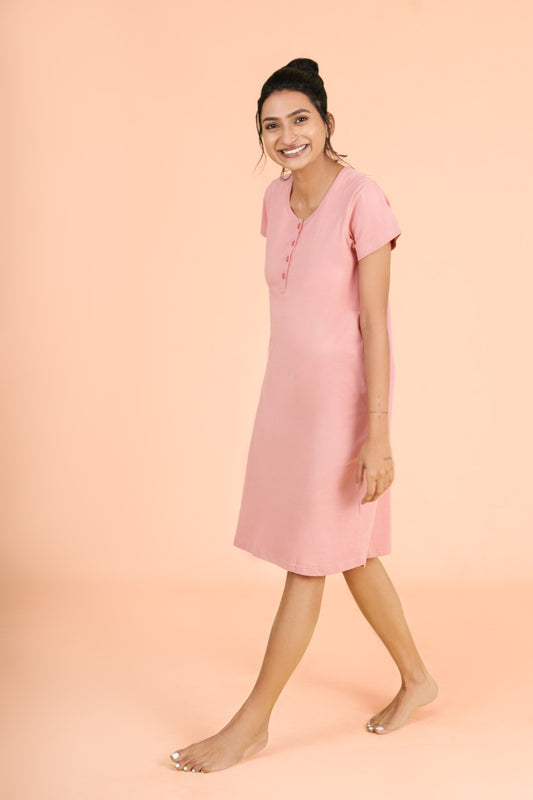 a woman in a pink dress holding a pink umbrella 