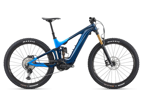 The Trance X Advanced E+ 0 model features Fox Live Valve suspension technology and Shimano Deore XT drivetrain components. Availability varies by 