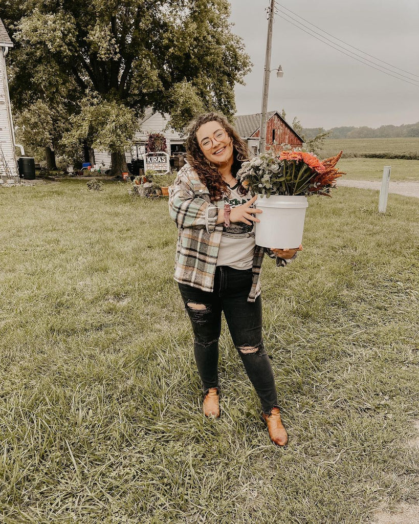 Taylor holding flowers wearing the Shop Tee